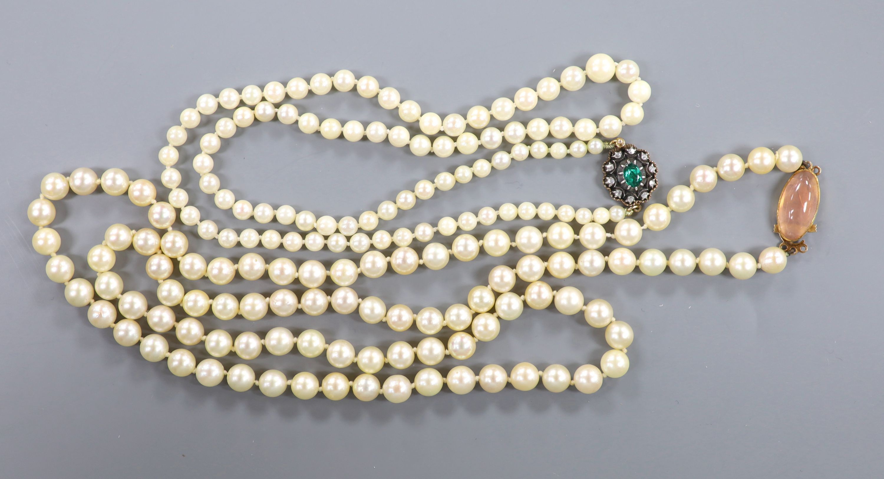 A single strand cultured pearl necklace with yellow metal and rose quartz clasp, 82cm and one other smaller necklace with yellow metal and two colour paste set clasp, 56cm.